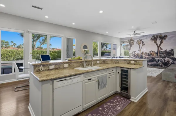 a kitchen with stainless steel appliances granite countertop a stove and a sink