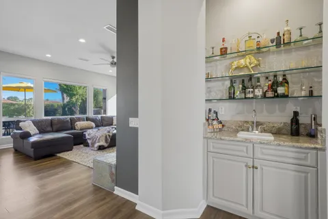 a view of a dining room with furniture a chandelier and wooden floor