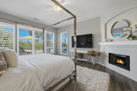 a bathroom with a granite countertop sink a large mirror a and a window