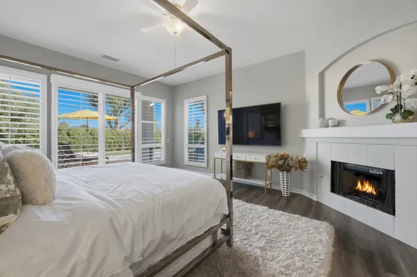 a bathroom with a granite countertop sink a large mirror a and a window