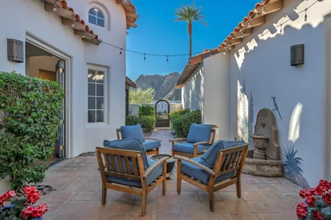 a view of a chairs and table in the patio