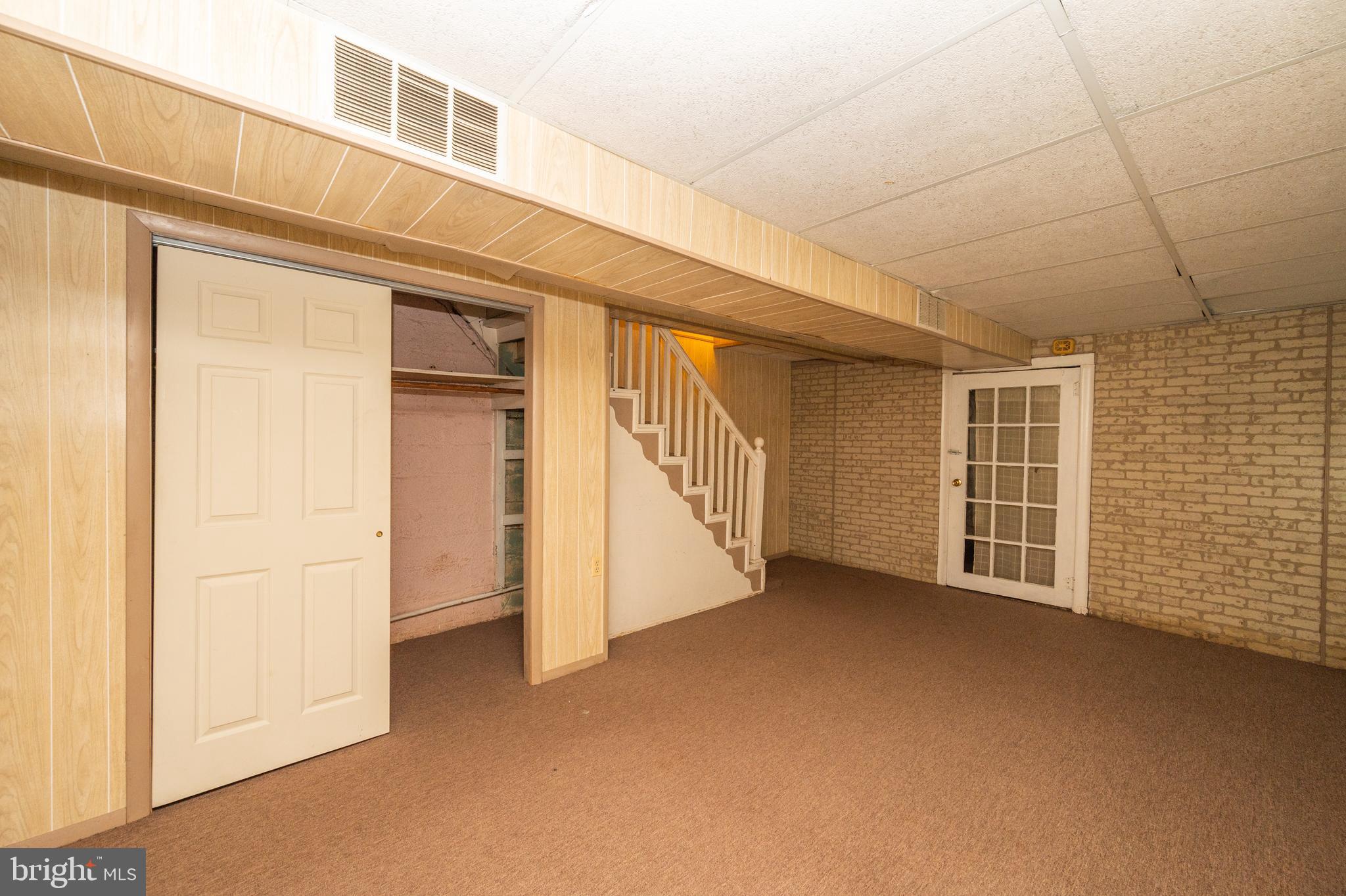 6306 Frederick Road Catonsville, MD 21228 - Photo 18 of 36 Door at bottom of stairs leads to storage/ utility