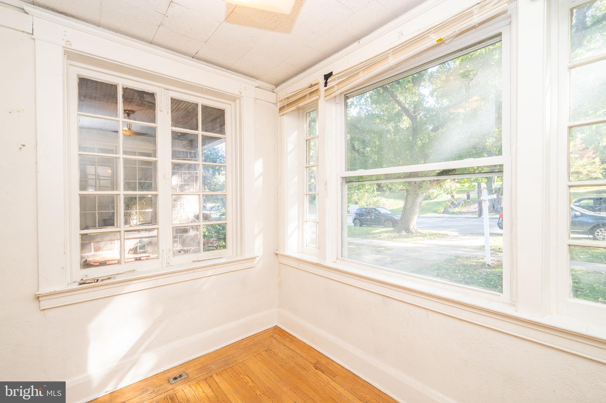 6306 Frederick Road Catonsville, MD 21228 - Photo 9 of 36 Sunroom looking over tree-lined Frederick Rd