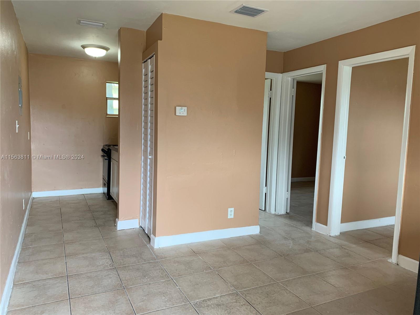 405 Northwest 5th Street, Unit 3 Pompano Beach, FL 33060 - Photo 2 of 6 an empty room with closet and a bathroom
