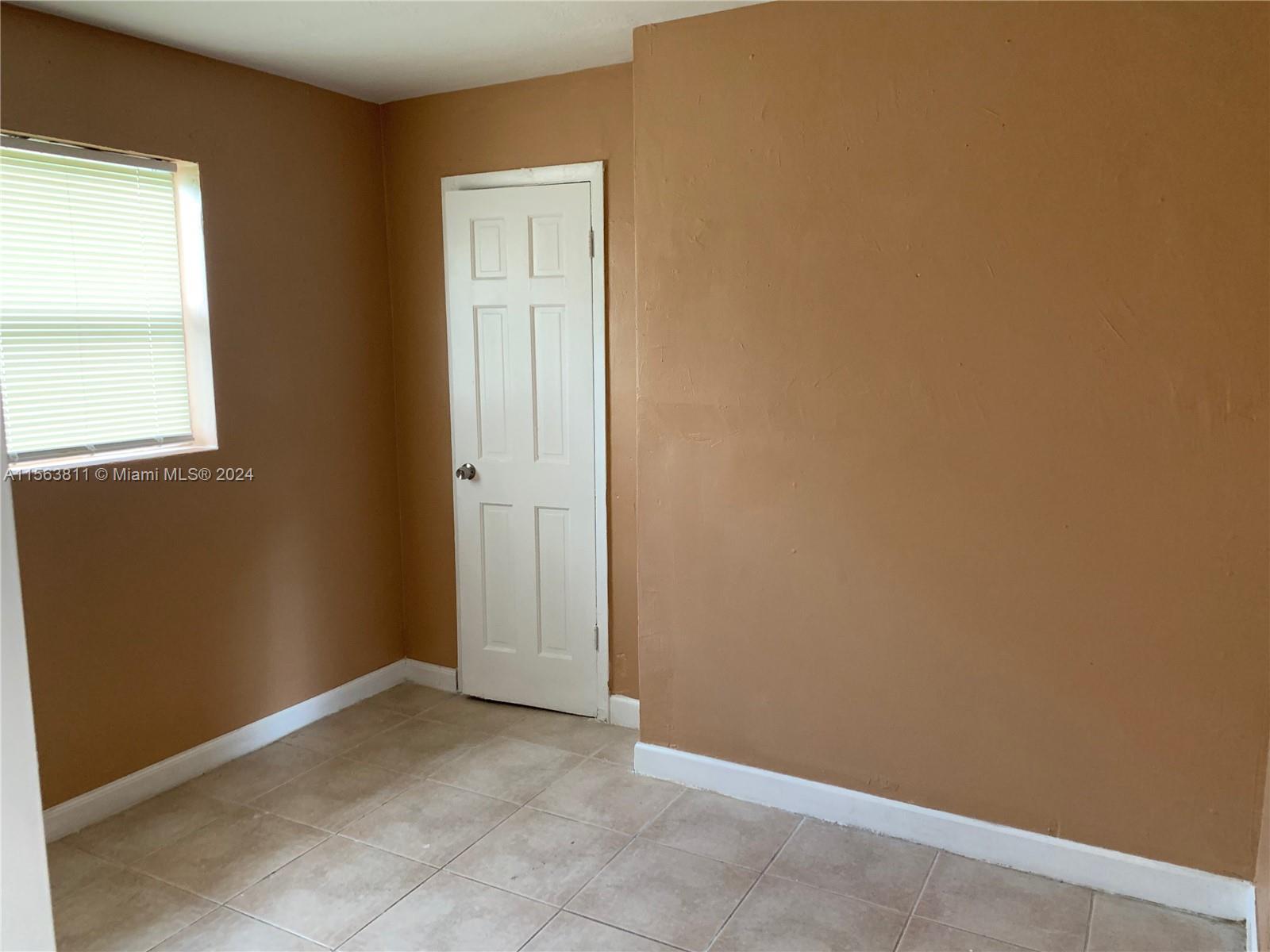 405 Northwest 5th Street, Unit 3 Pompano Beach, FL 33060 - Photo 4 of 6 an empty room with windows