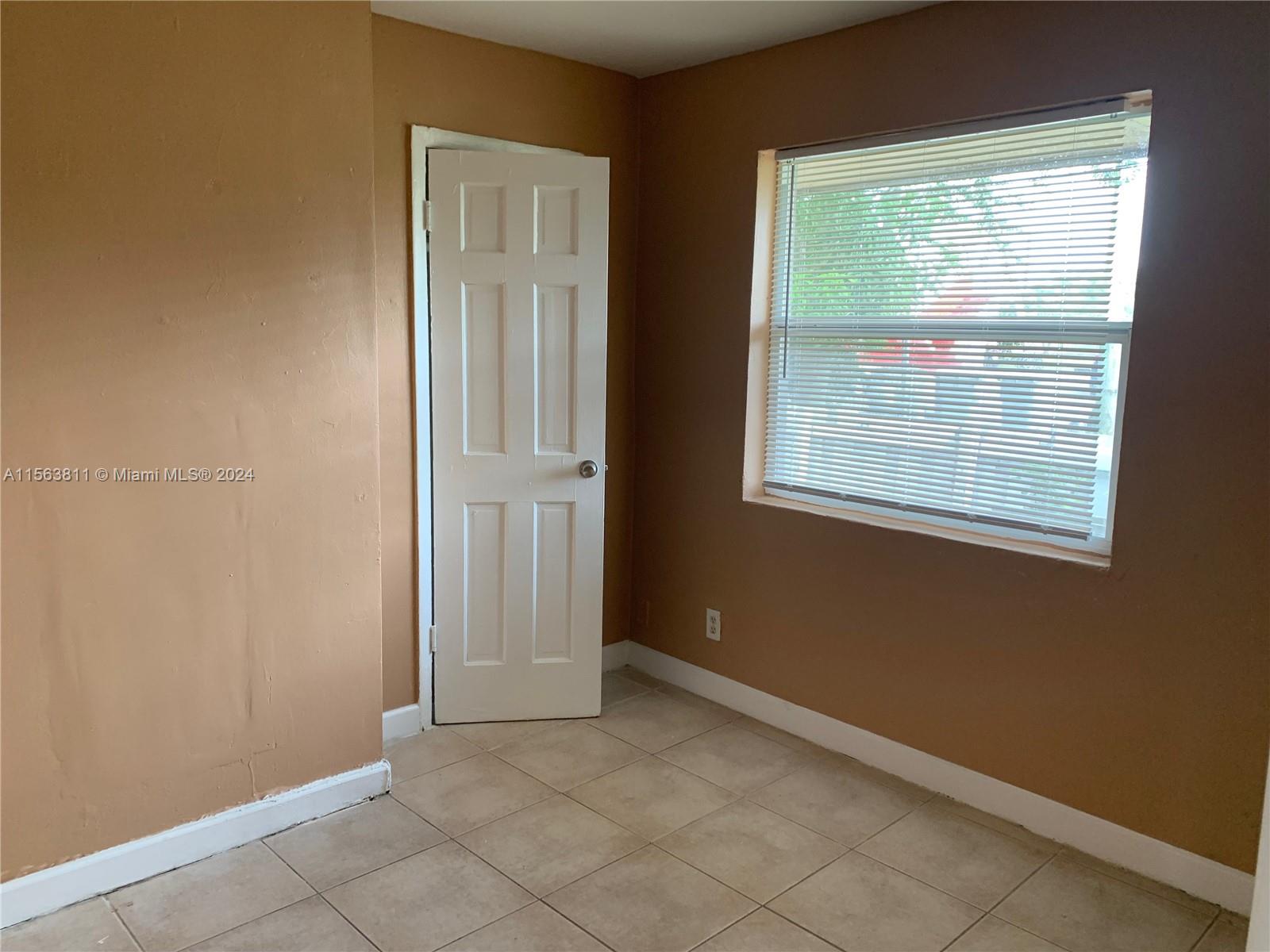 405 Northwest 5th Street, Unit 3 Pompano Beach, FL 33060 - Photo 5 of 6 an empty room with windows