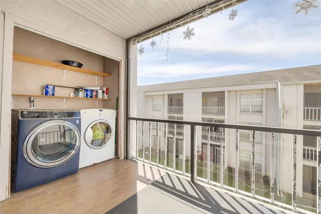 a view of a house with a yard and potted plants