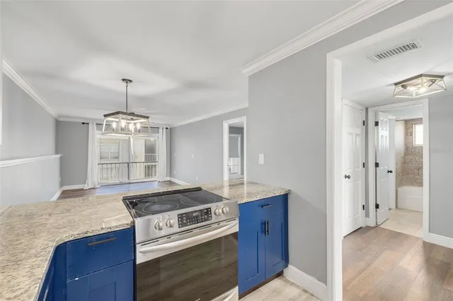a kitchen with a stove and white cabinets