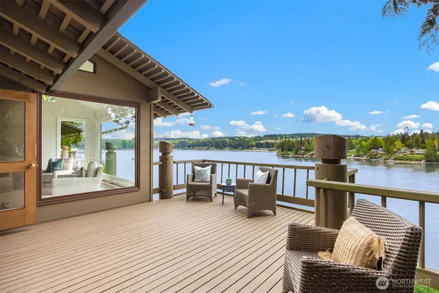 a view of a balcony with wooden floor and outdoor seating