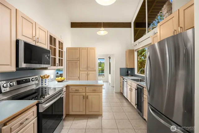a kitchen with stainless steel appliances a stove microwave and a refrigerator