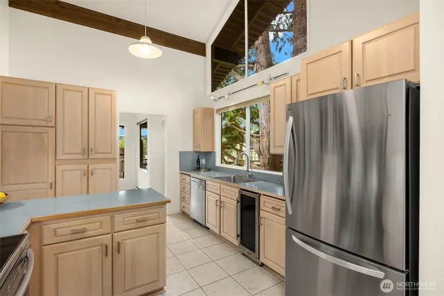 a kitchen with stainless steel appliances a refrigerator sink and cabinets
