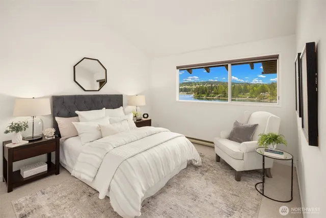 a bedroom with a bed a couch and a window