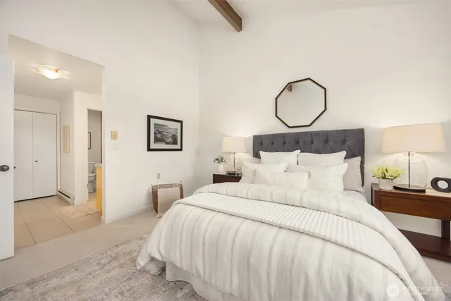 a bedroom with bed and a chandelier