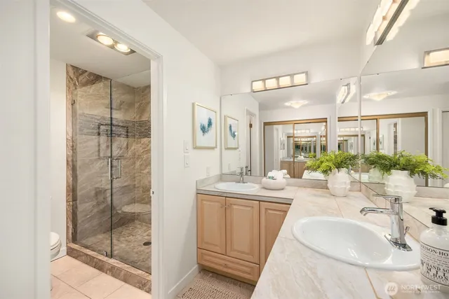 a bathroom with a granite countertop sink mirror and shower