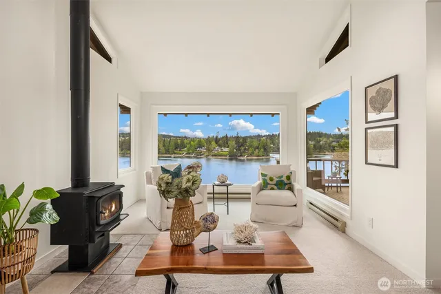 a living room with fireplace furniture and a large window