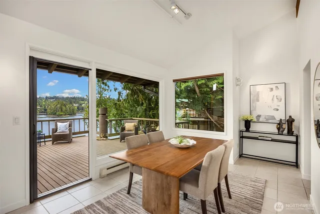 a dining room with furniture and large windows