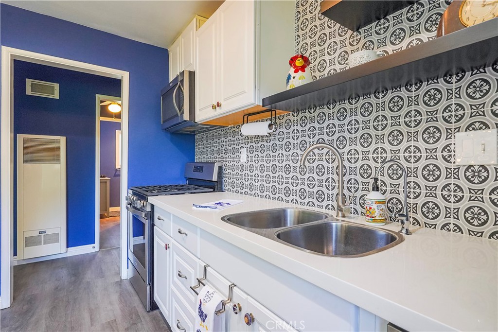 163 North Center Street Redlands, CA 92373 - Photo 16 of 37 a kitchen with stainless steel appliances a sink a stove and a refrigerator