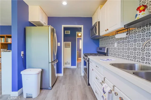 a kitchen with a sink and refrigerator