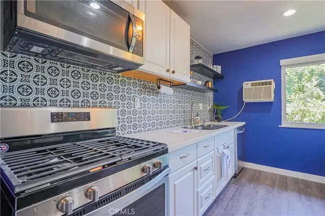 a stove top oven sitting inside of a kitchen