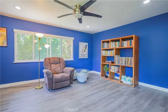 a living room with furniture and a book shelf