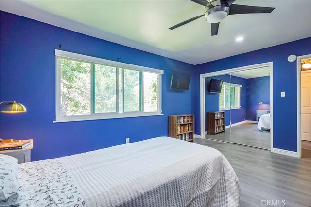 a bedroom with a large bed and a large window