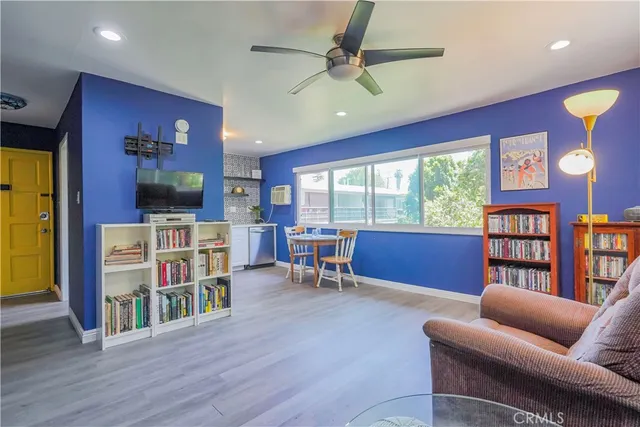 a living room with lots of furniture and a book shelf