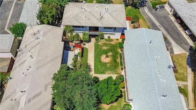 an aerial view of a house with a yard and garden