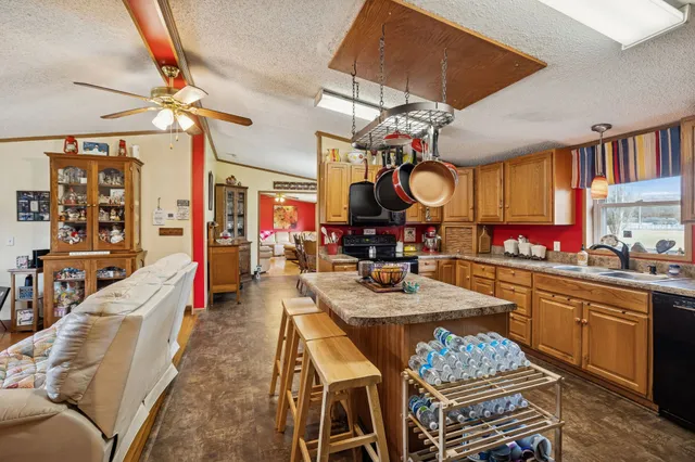 a kitchen with a table chairs stove and cabinets