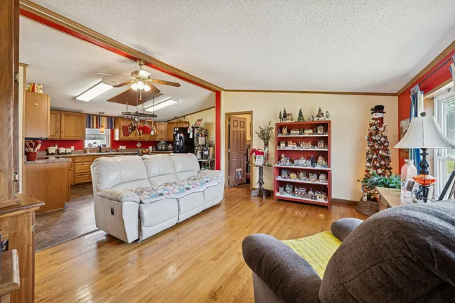 a living room with furniture and a book shelf