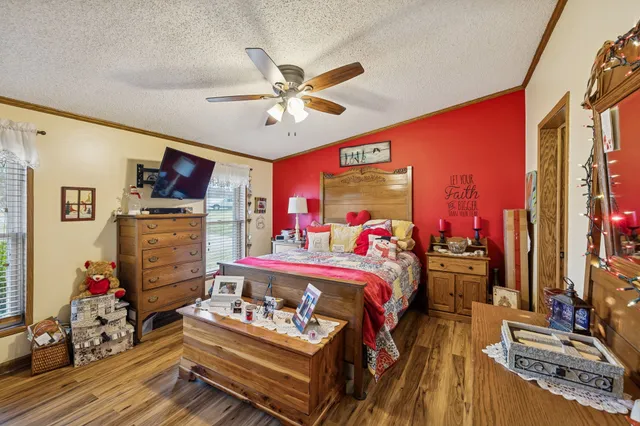 a bed room with furniture and a flat screen tv