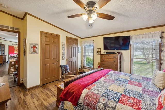 a bedroom with a bed and a flat screen tv