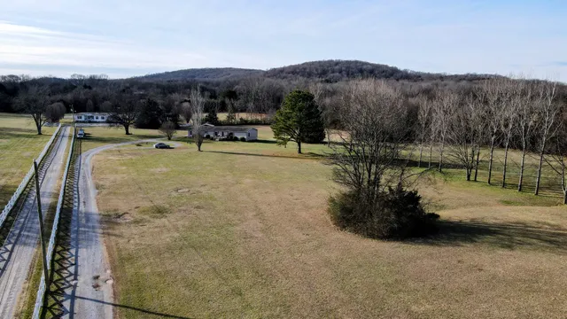 a view of a swimming pool with a yard and mountain view