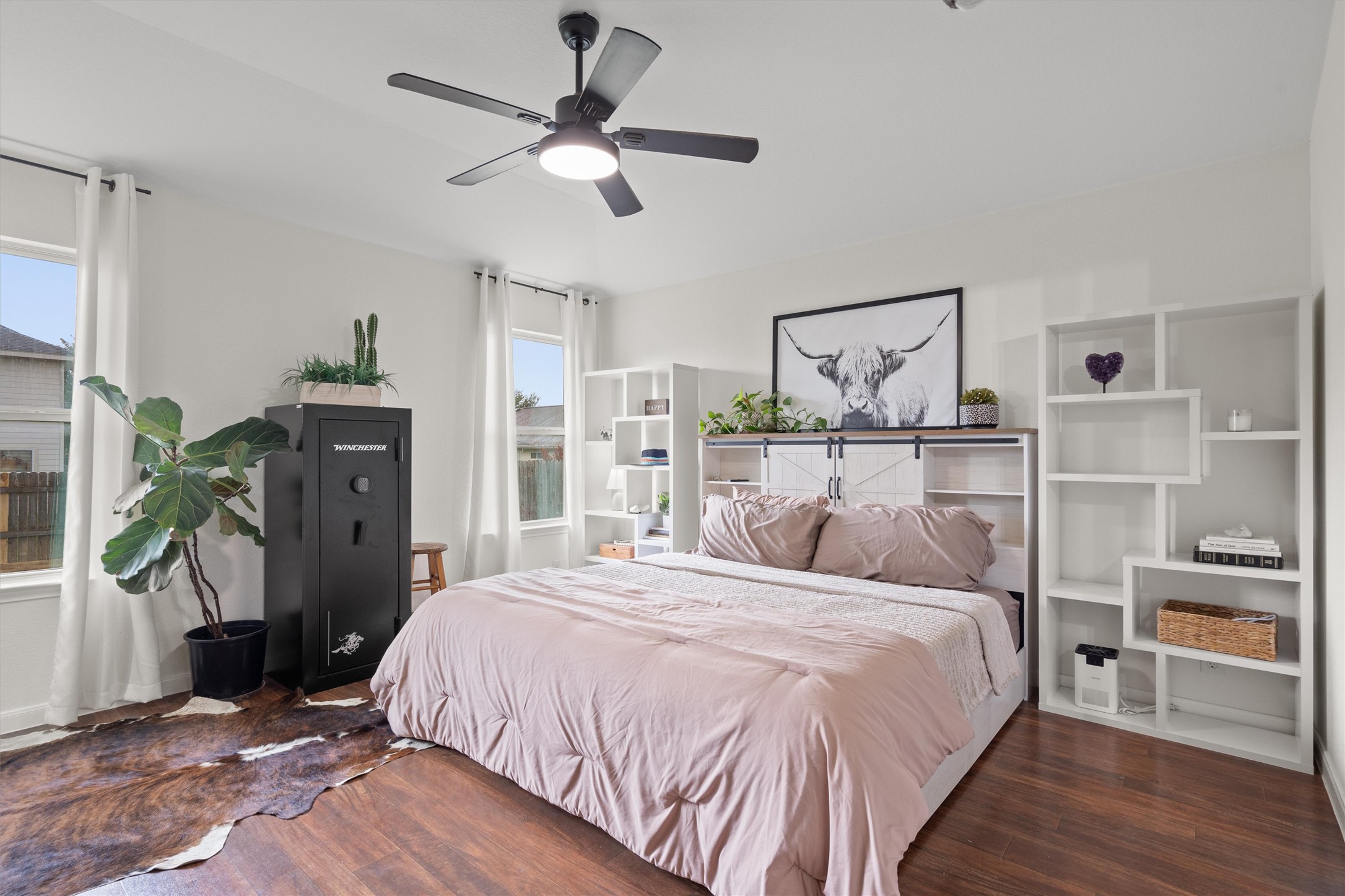 606 Old Peak Road Georgetown, TX 78626 - Photo 12 of 23 a bedroom with a large bed and a chandelier
