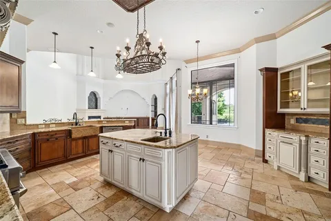 a kitchen with a sink stove and microwave