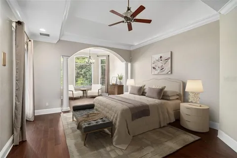 a bedroom with a bed and a large window