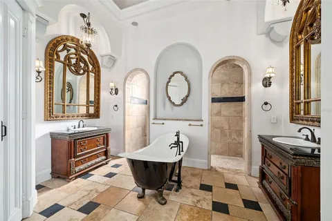 a spacious bathroom with a tub a sink and a mirror