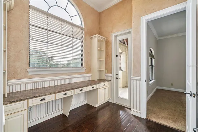 an aerial view of residential houses with outdoor space and trees