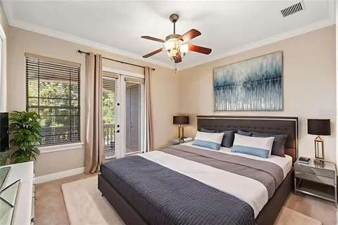 a bedroom with a large bed and a chandelier