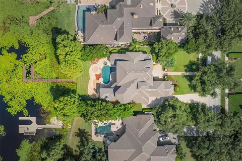 an aerial view of a house with a garden and yard