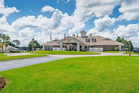 a aerial view of a house with a big yard and large trees