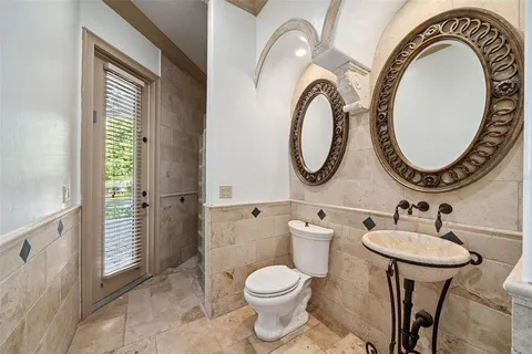 a bathroom with a toilet a sink and a mirror