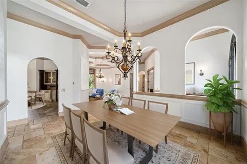 a view of a dining room with furniture and a chandelier