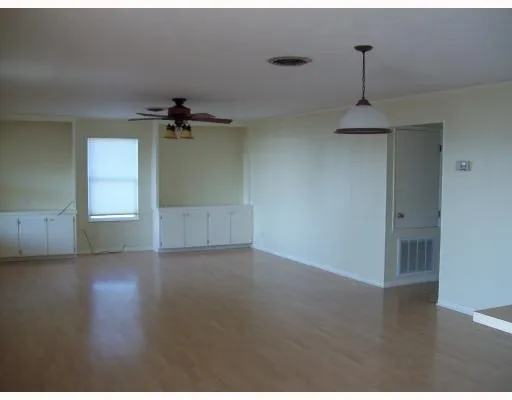 a kitchen with cabinets stainless steel appliances and sink