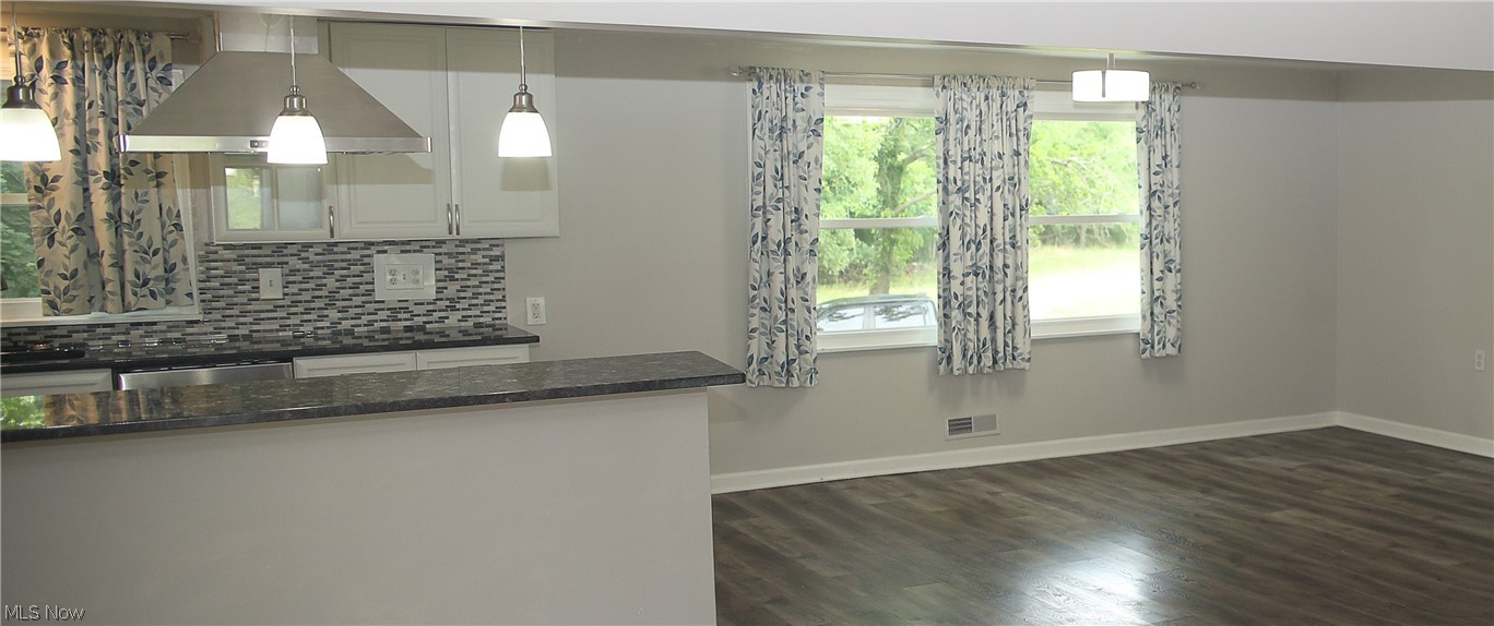 1087 Krumroy Road Akron, OH 44306 - Photo 9 of 23 Kitchen featuring white cabinetry, a mosaic tile backsplash, and dark countertops