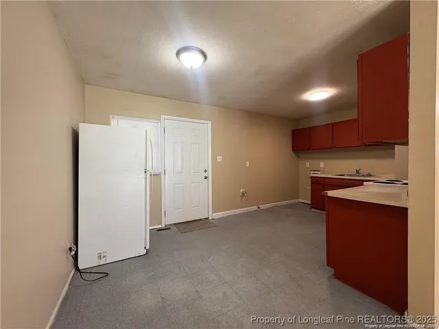 a view of kitchen with stainless steel appliances granite countertop cabinets and a refrigerator