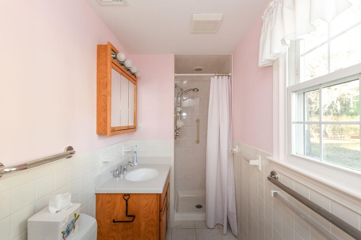 254 Cedric Road Centerville, MA 02632 - Photo 20 of 24 a bathroom with a sink a toilet and a window
