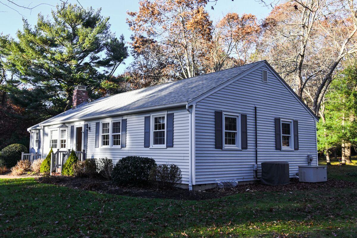 254 Cedric Road Centerville, MA 02632 - Photo 2 of 24 a front view of a house with garden