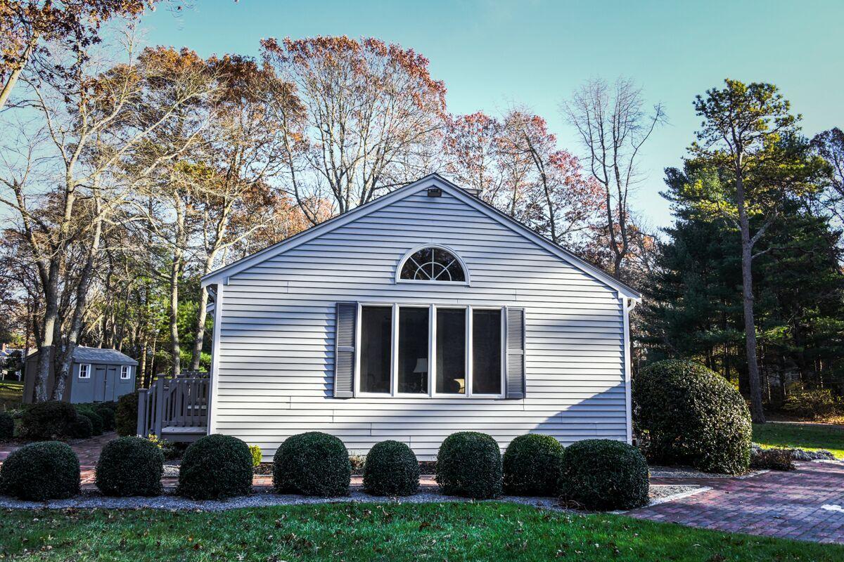 254 Cedric Road Centerville, MA 02632 - Photo 21 of 24 a front view of a house with a yard