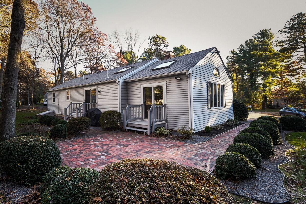 254 Cedric Road Centerville, MA 02632 - Photo 24 of 24 a view of a house with a yard and plants