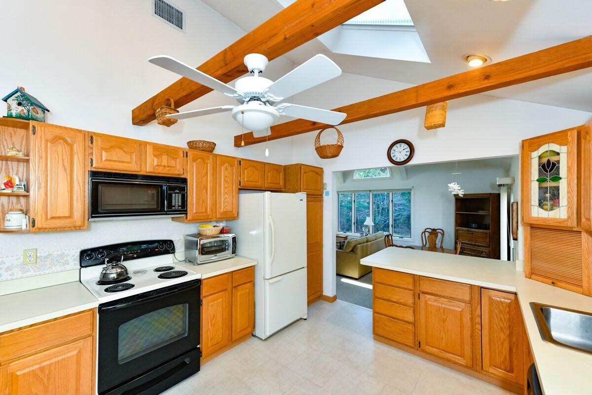 254 Cedric Road Centerville, MA 02632 - Photo 4 of 24 a kitchen with stainless steel appliances granite countertop a stove a sink and a refrigerator